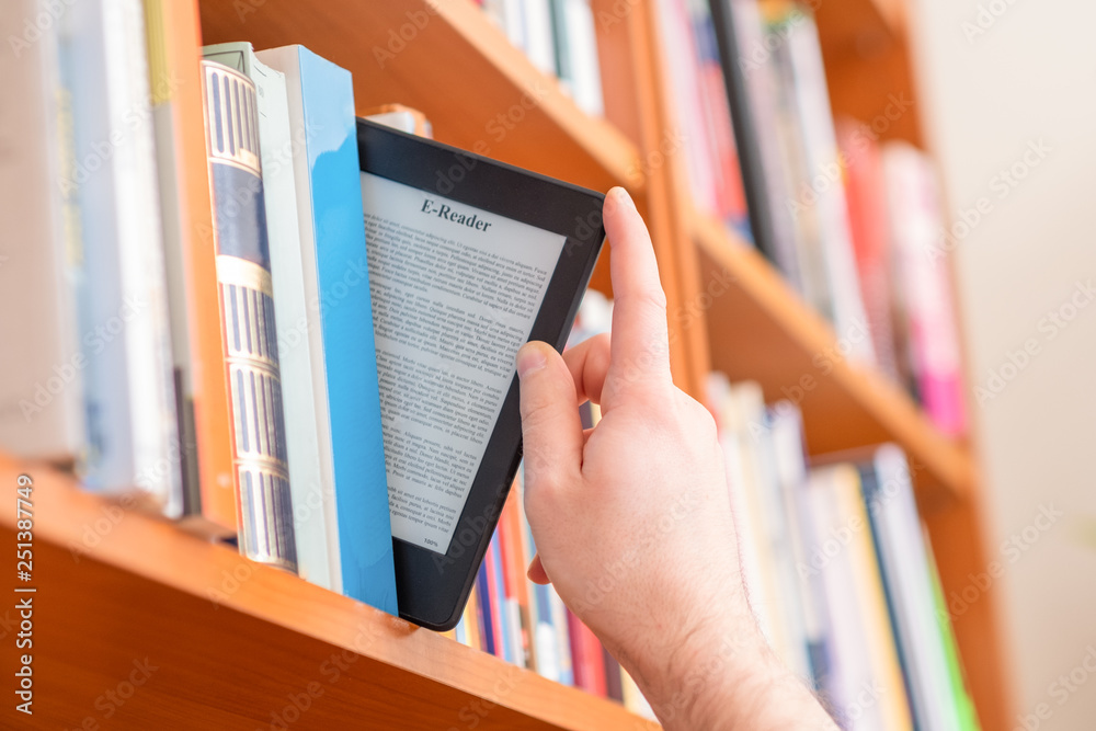 Hands holding and keeping ebook on bookshelf background Stock Photo