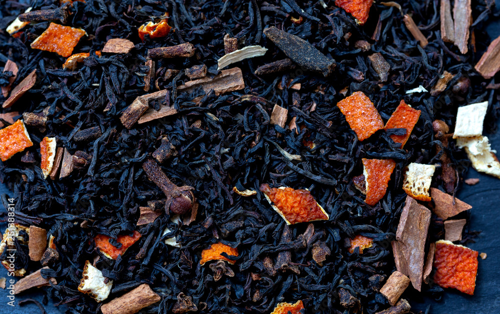 Dry tea with fruit and flower petals as background top view