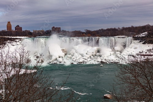 Wallpaper Mural Niagara Falls CANADA - February 23, 2019: Winter frozen view at the American side of beautiful Niagara Falls cower with snow and ice Torontodigital.ca