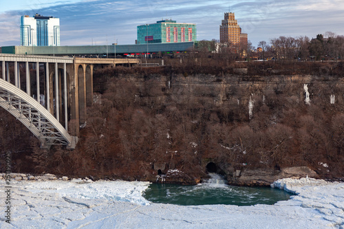 Niagara Falls CANADA - February 23, 2019: Winter frozen view at the Rainbow bridge, steel arch bridge connecting the United States and Canada photo