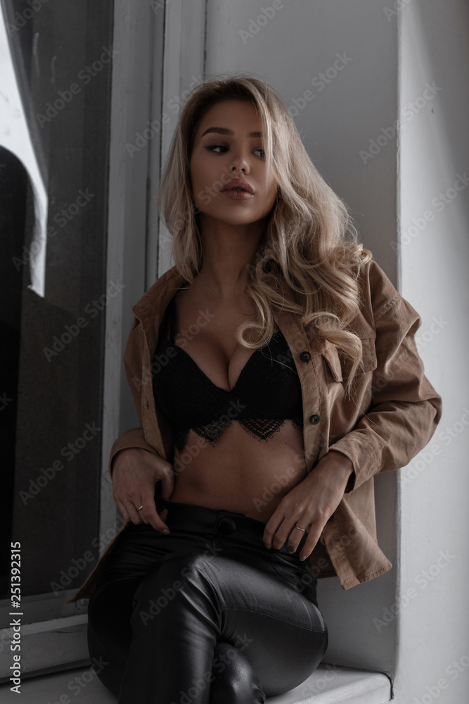 Charming pretty sexy young blond woman with beautiful breasts in a chic  lace bra in trendy