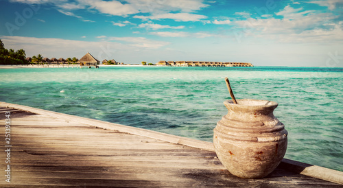 Wooden jetty on the ocean and Maldivian resort
