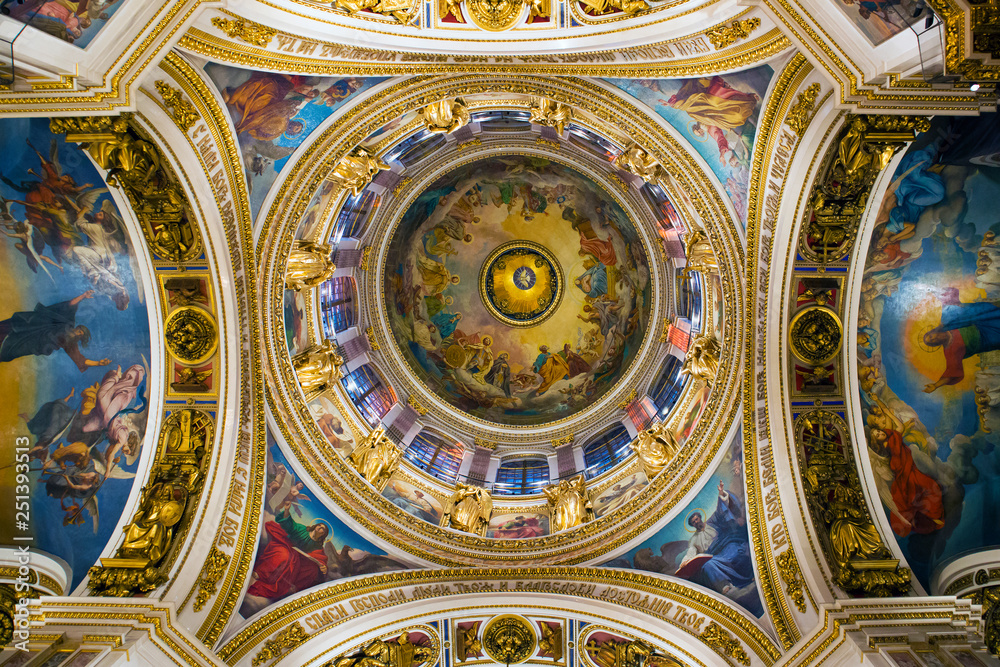 Fragment of rich decorated interior of ancient Saint Isaac's orthodox cathedral, ceiling painting