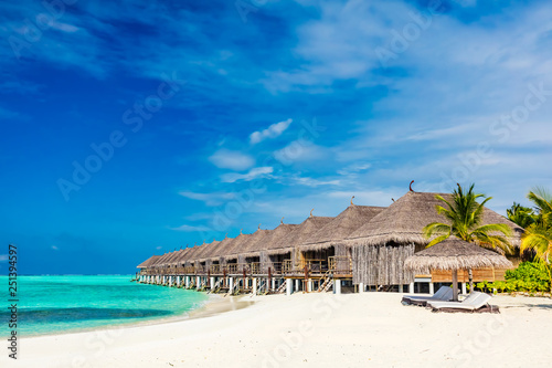 Tropical beach with straw cabins on Maldives. © Photocreo Bednarek