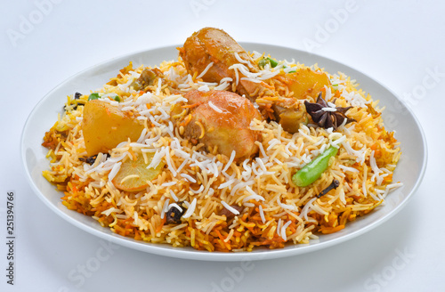 Chicken Biryani, A famous Indian Sub-continent savory rice dish mixed with spicy marinated chicken, spices and flavorful saffron.