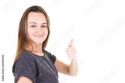 Young happy cheerful woman showing thumb up giving the thumbs up against a white background Place for text