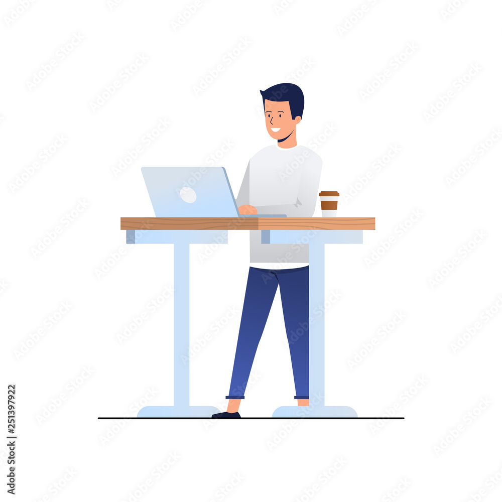 man stands at his desk with a laptop man stands at his desk with a laptop