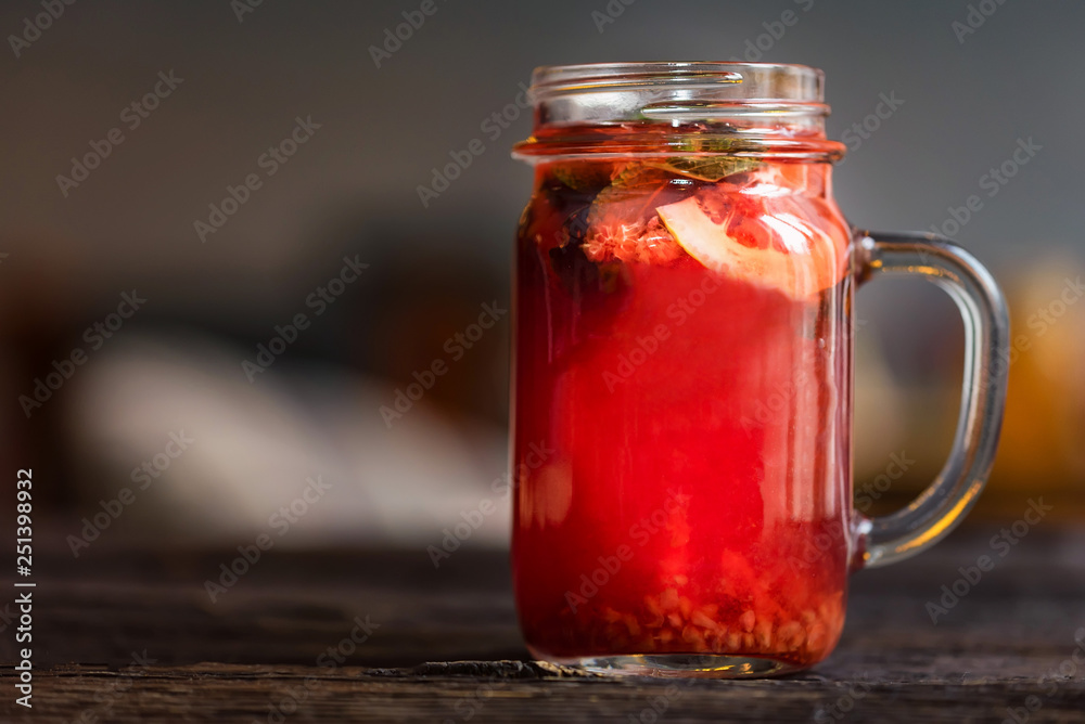 Close up glass jar with delicious healthy raspberry tea drink