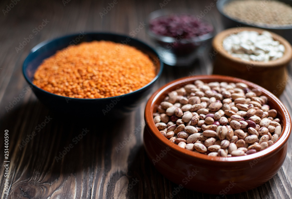 Assortment of legumes: beans and lentils. Raw healthy food. Vegetable protein. Dark background. Close up. Space for text Assortment of legumes: beans and lentils. Raw healthy food. Vegetable protein. Dark background. Close up. Space for text