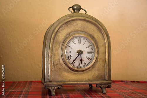 Old clock vintage style with Roman numerals. Retro bronze clock