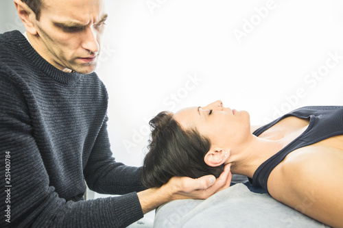Close-up of a physiotherapist massaging the neck of a beautiful young woman. Concept of health treatments and physiotherapy