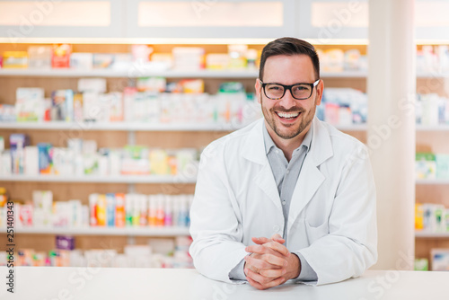 Portrait of cheerful male pharmacist. photo