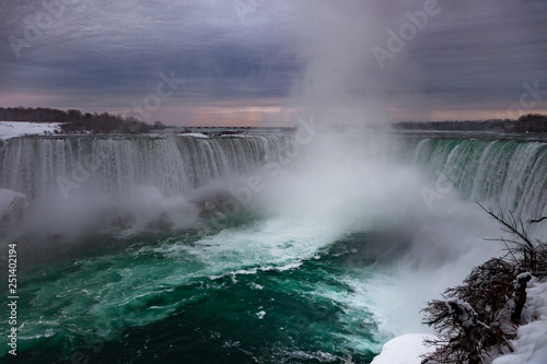 Fototapeta Naklejka Na Ścianę i Meble -  Niagara Falls CANADA - February 23, 2019: Winter frozen idyll at Horseshoe Falls, the Canadian side of Niagara Falls, view showing as well as the upper Niagara River