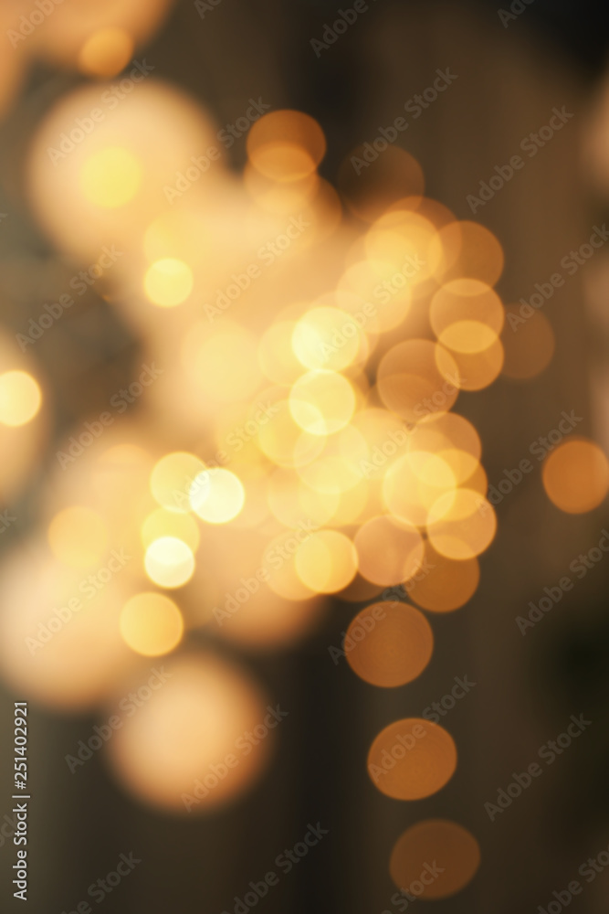Obraz premium Blurred view of gold lights on dark background. Bokeh effect