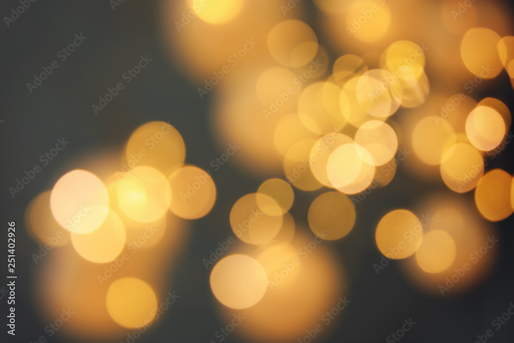 Blurred view of gold lights on dark background. Bokeh effect Blurred view of gold lights on dark background. Bokeh effect
