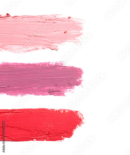 Strokes of lipstick on white background, top view