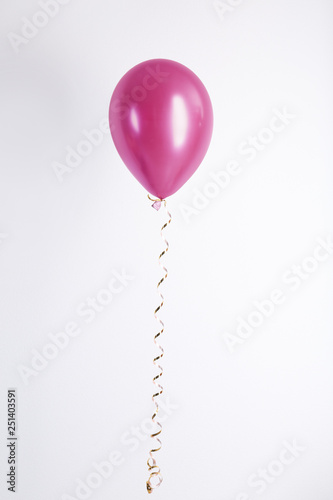 Color balloon with ribbon on white background
