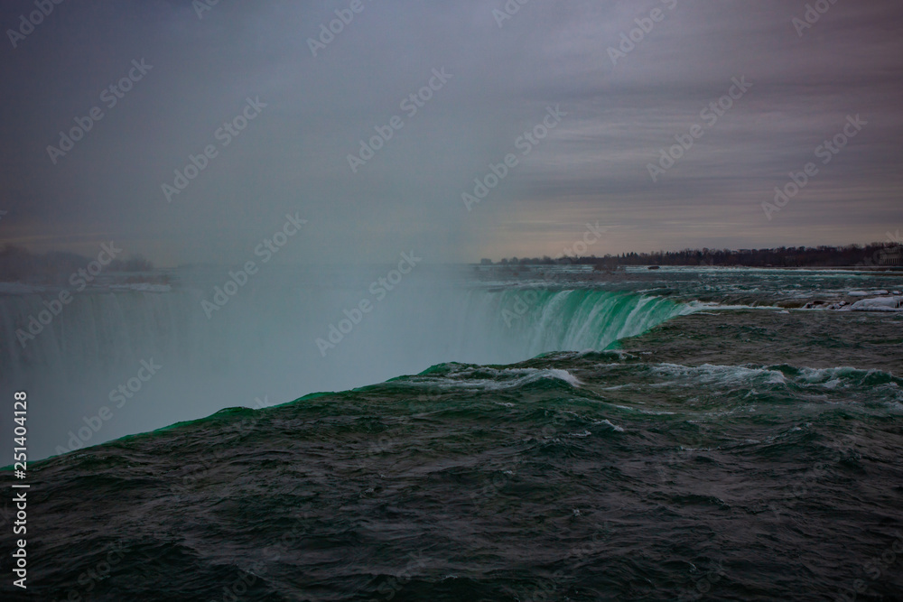 Niagara Falls CANADA - February 23, 2019: Winter frozen idyll at Horseshoe Falls, the Canadian side of Niagara Falls, view showing as well as the upper Niagara River