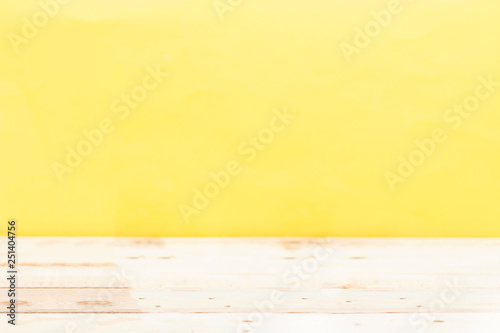 Wooden board empty table in front of blurred yellow background