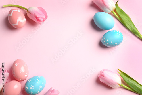 Flat lay composition with painted Easter eggs on color background, space for text