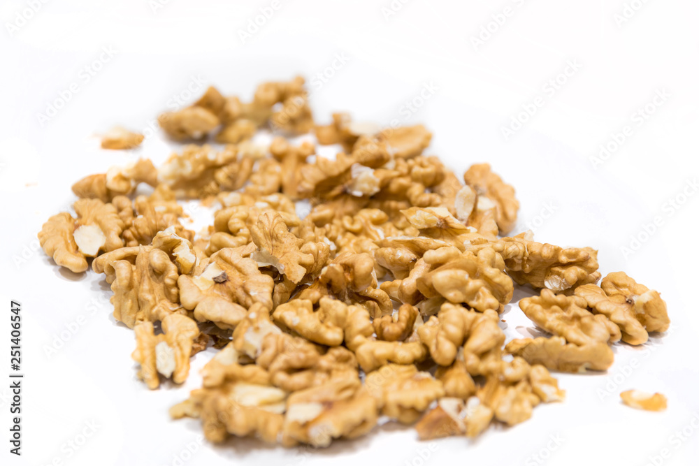 Walnut kernels, close-up macro, isolated on a white background. Walnut kernels, close-up macro, isolated on a white background.