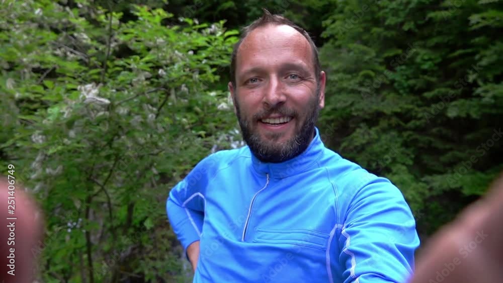 Man doing selfies with the waterfall behind him, slow motion shot at 240fps Man doing selfies with the waterfall behind him, slow motion shot at 240fps