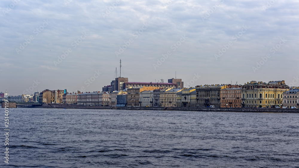 Buildings along the Kutuzova embankment of the Neva river and ex-KGB headquarter (Bolshoy Dom) in the background in Saint-Petersburg, Russia.