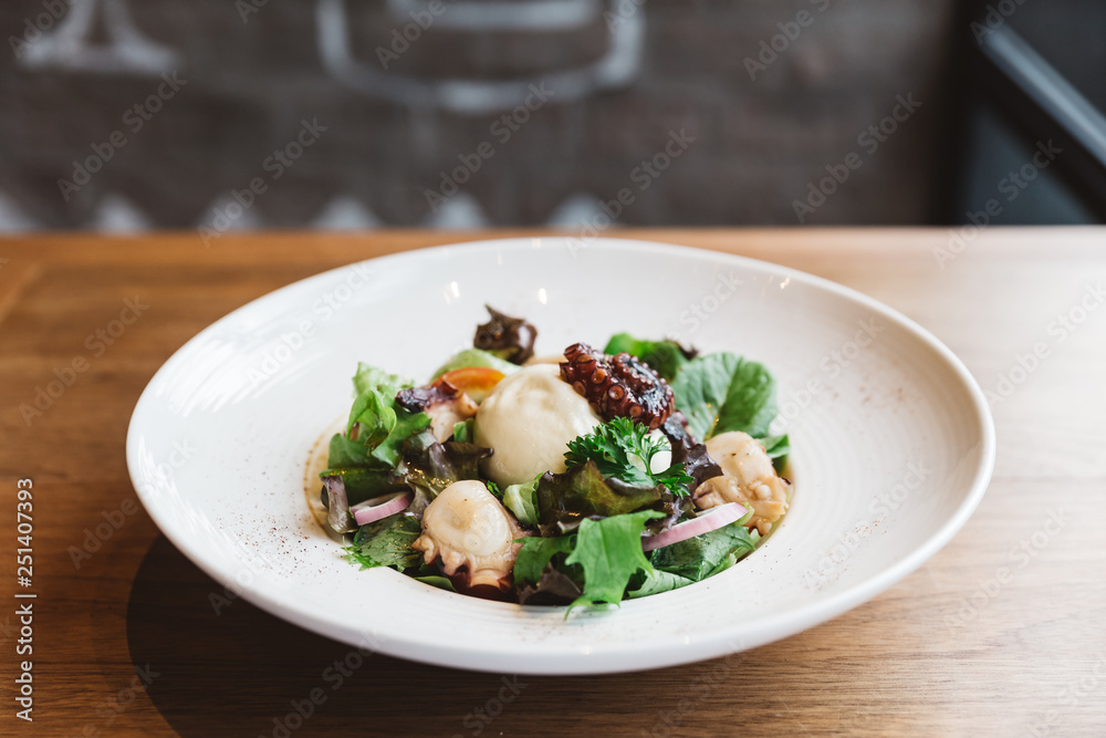 Smoked Galician Octopus with Burrata Cheese, radish, green oak and tomato. Smoked Galician Octopus with Burrata Cheese, radish, green oak and tomato.