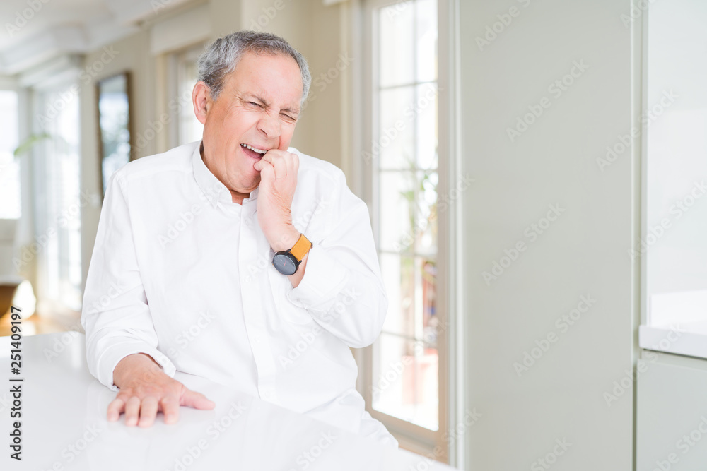 Handsome senior man at home looking stressed and nervous with hands on mouth biting nails. Anxiety problem. Handsome senior man at home looking stressed and nervous with hands on mouth biting nails. Anxiety problem.