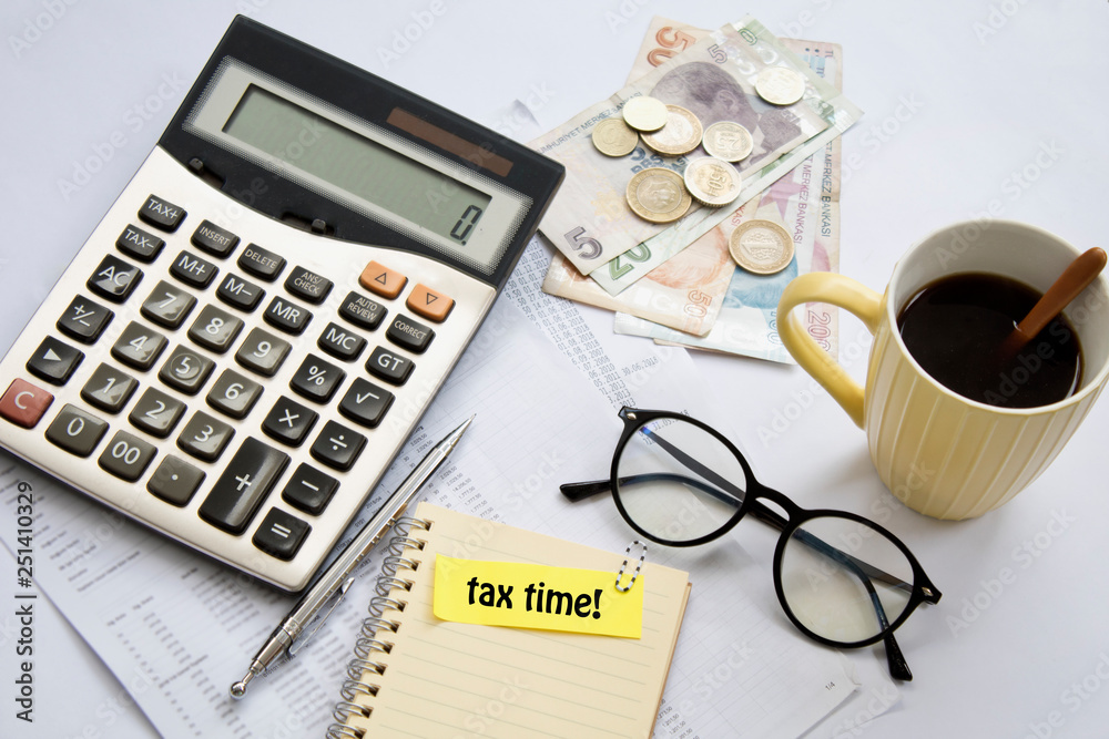 tax time concept. calculator, pen and coffee on table. tax time concept. calculator, pen and coffee on table.