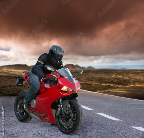 red Biker on a volcanic landscape