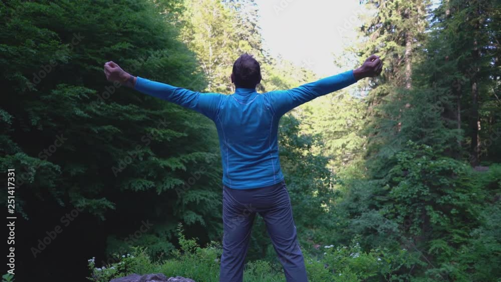 custom made wallpaper toronto digitalMan standing in the forest and stretching his muscles 
