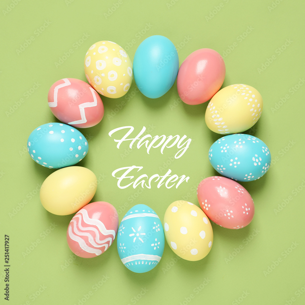 Frame made of colorful painted eggs and text Happy Easter on color background, top view