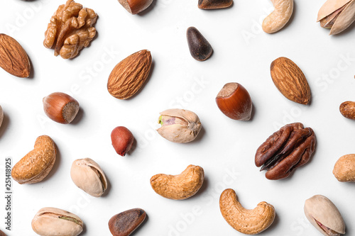 Composition with organic mixed nuts on white background, top view