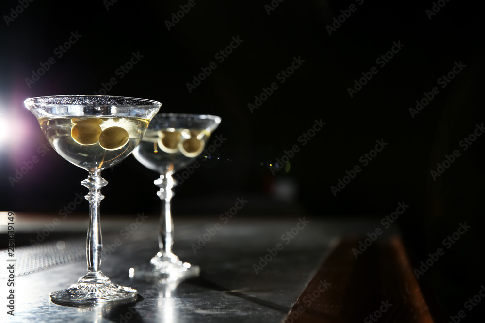 Glasses of martini cocktail with olives on bar counter. Space for text Glasses of martini cocktail with olives on bar counter. Space for text
