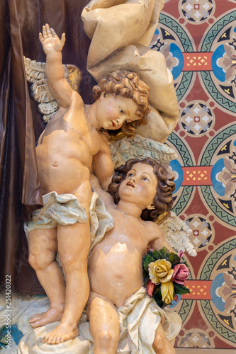 PRAGUE, CZECH REPUBLIC - OCTOBER 17, 2018: The detail of angels from carved statue of Saint Theresia in church Svatého Cyrila Metodeje by Bretislav Kafka (1891 - 1967).