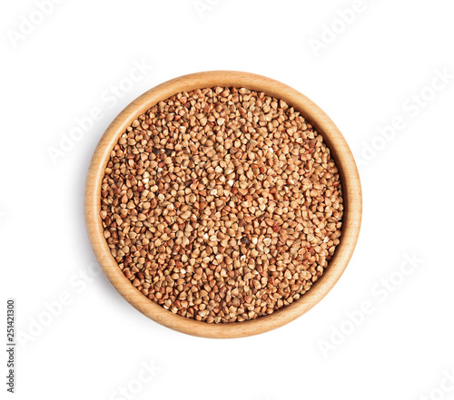 Bowl with uncooked buckwheat on white background, top view