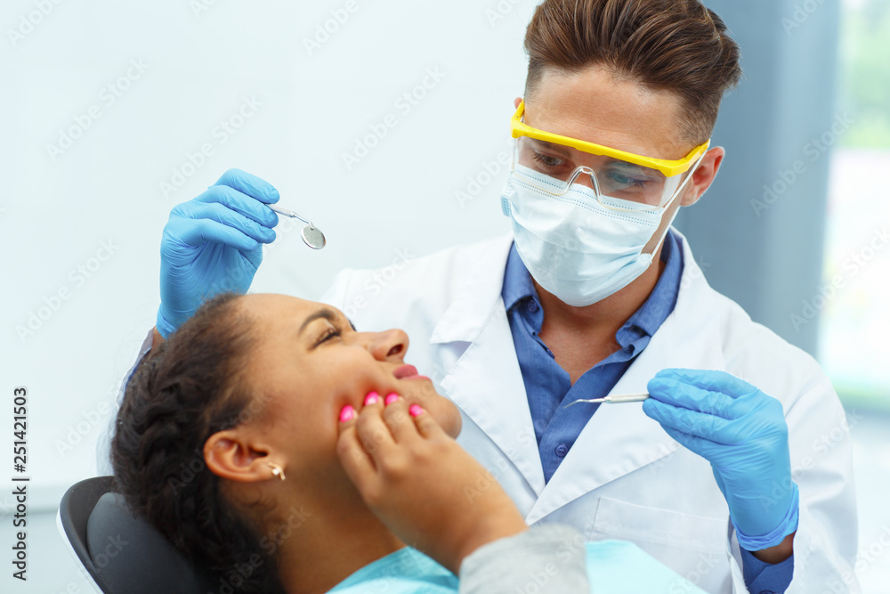 Woman having toothache, touching face with hands sitting in dental chair. Woman having toothache, touching face with hands sitting in dental chair.