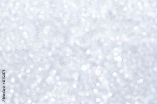 High resolution silver colored blurred bokeh background. Abstract full frame shiny glitter background for Christmas, New Year, holiday season and celebration.