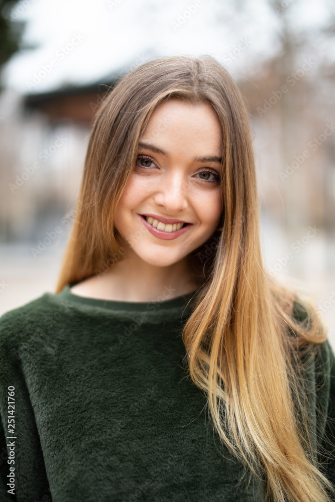 Portrait of happy smiling young blond woman in a park in autumn Portrait of happy smiling young blond woman in a park in autumn