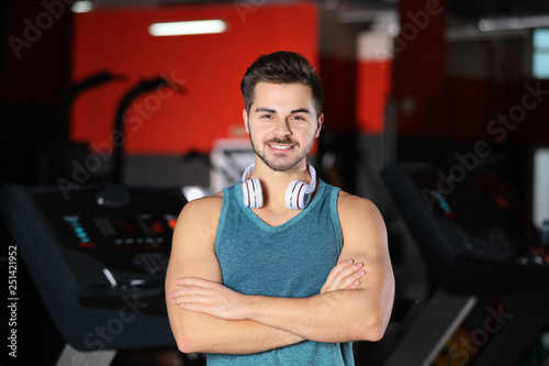 Handsome young man with headphones at gym