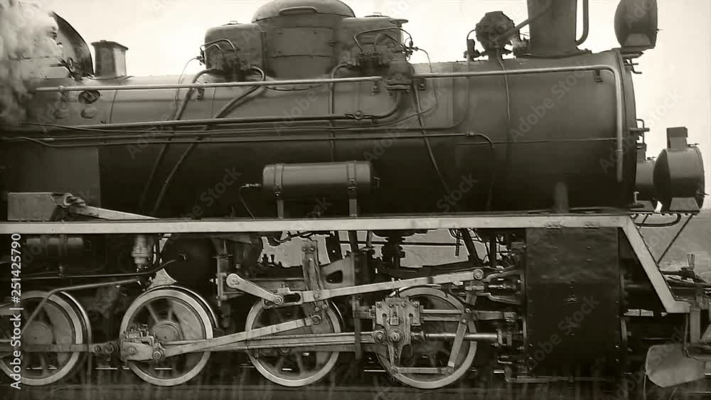 Old passangers train running on the tracks. Retro locomotive with steam engine loopable black and white footage.