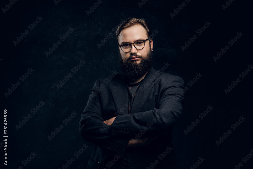 Portrait of a hipster crossed arms in a studio on a black background