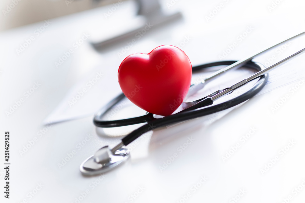 Stethoscope and heart lying on the white desk. Stethoscope and heart lying on the white desk.