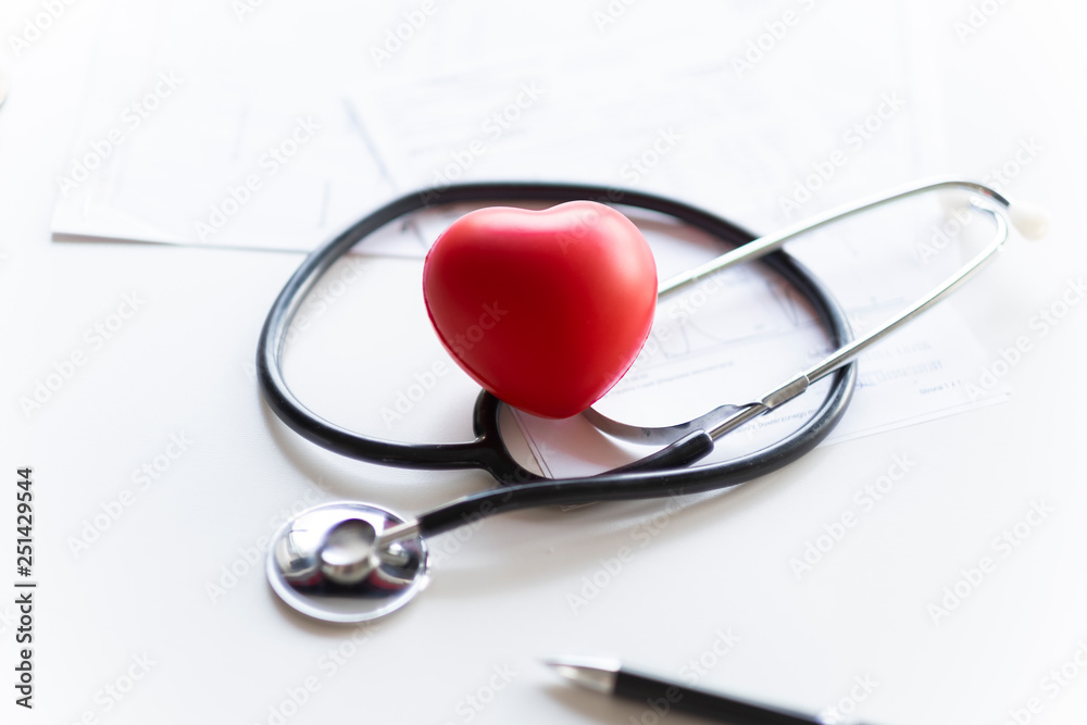 Stethoscope and heart lying on the white desk. Stethoscope and heart lying on the white desk.