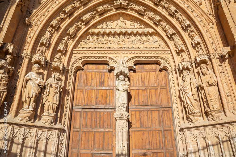 PALMA DE MALLORCA, SPAIN - JANUARY 30, 2019: The south portal of cathedral La Seu with the stone relief of Last Supper  by masters Pere Morey, and Guillem Sagrera Sagrera (1389 - 1394).