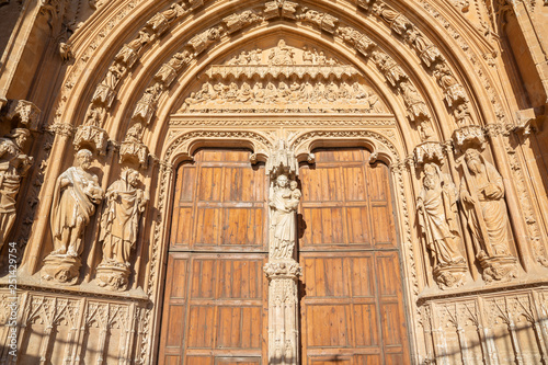 PALMA DE MALLORCA, SPAIN - JANUARY 30, 2019: The south portal of cathedral La Seu with the stone relief of Last Supper  by masters Pere Morey, and Guillem Sagrera Sagrera (1389 - 1394). photo