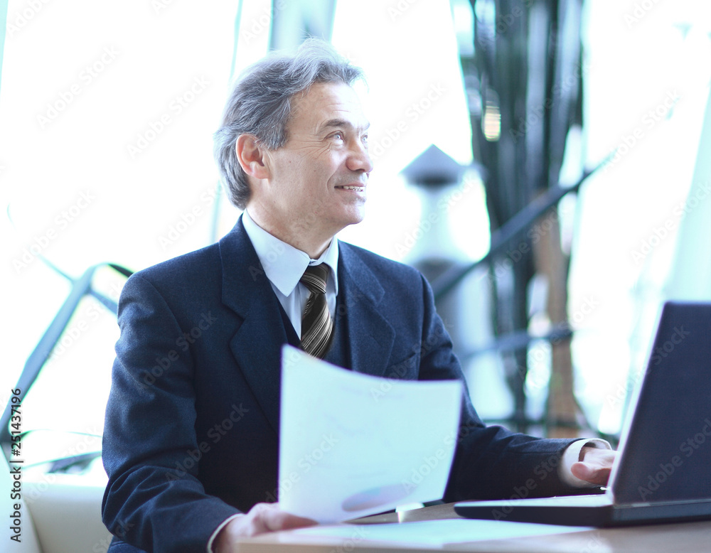 businessman working with business documents sitting at his Desk. businessman working with business documents sitting at his Desk.