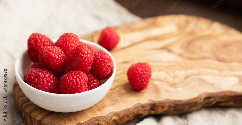 Fresh Raspberries In A Bowl On Linen Background, Space For Text