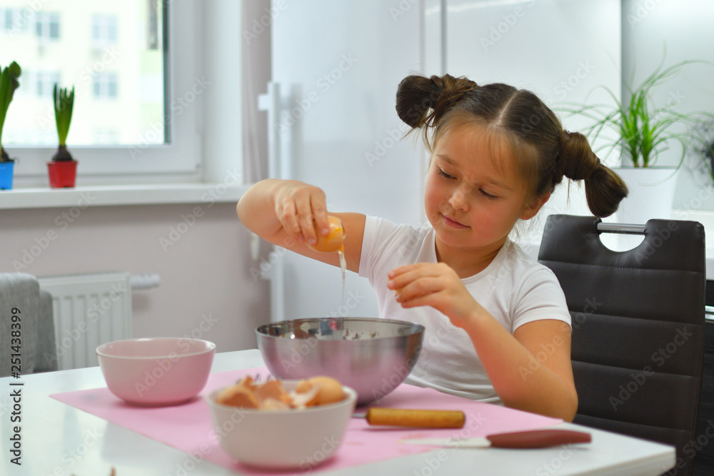 Little girl preparing cookies in kitchen at home. Cooking homemade food. Little girl preparing cookies in kitchen at home. Cooking homemade food.